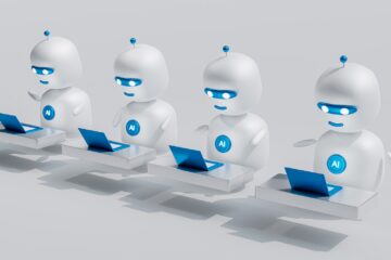 un groupe de robots blancs assis sur des ordinateurs portables